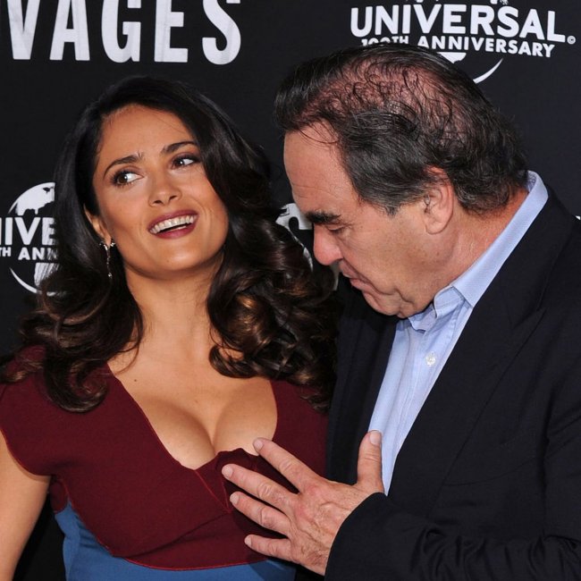 Salma Hayek and an admiring director Oliver Stone.jpg