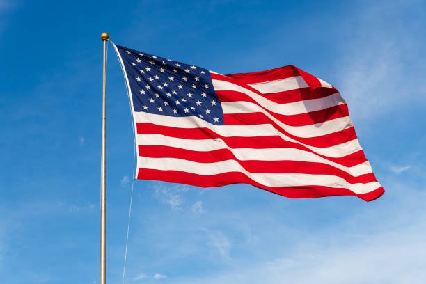 vibrant-colored-american-flag-waving-in-the-wind-lit-by-natural-sunlight.jpg