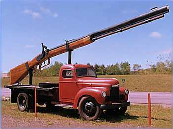 A_very_large_gun_on_the_back_of_some_old-timy_truck.png