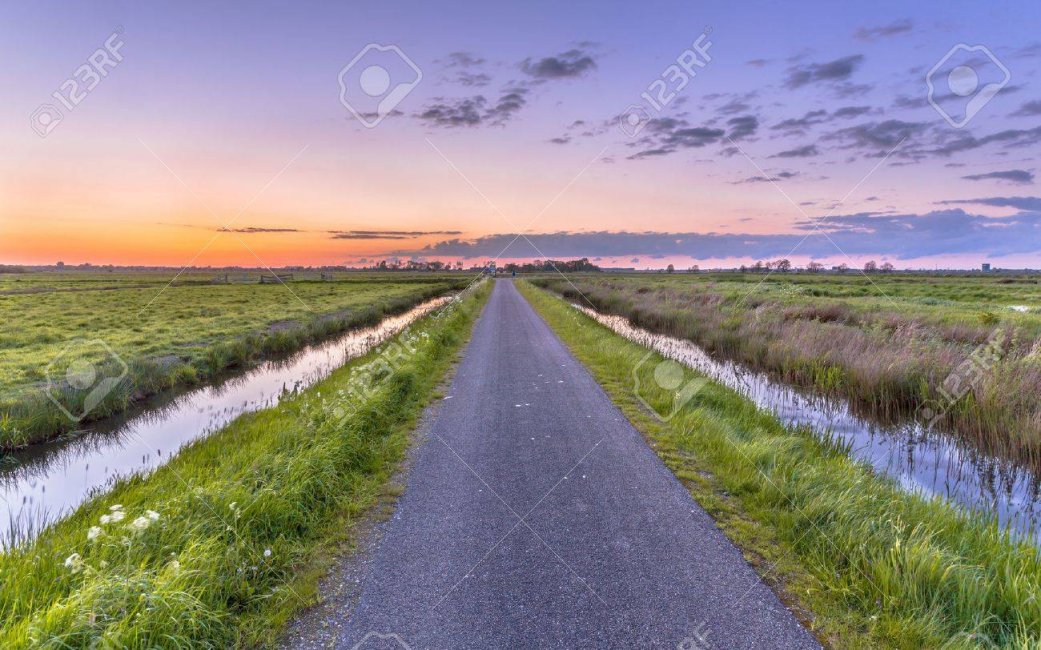 62147391-road-with-ditches-in-flat-and-open-polder-countryside-in-holland.jpg